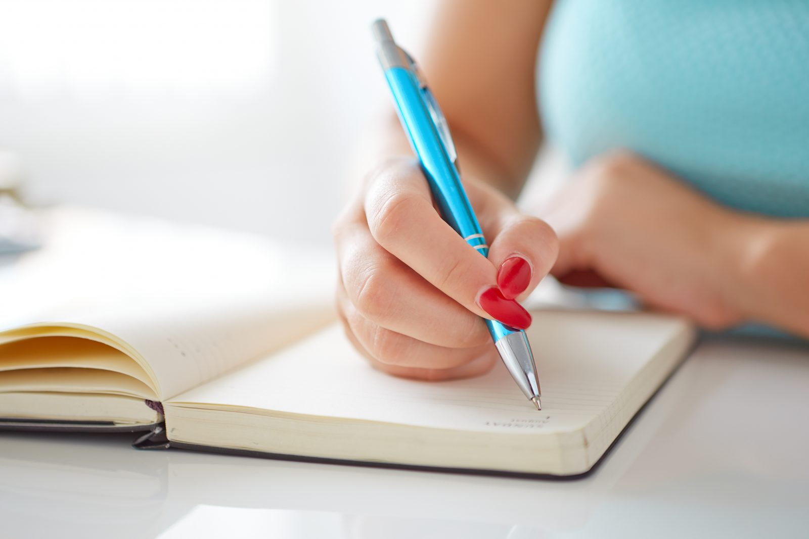 Young woman writing in a journal