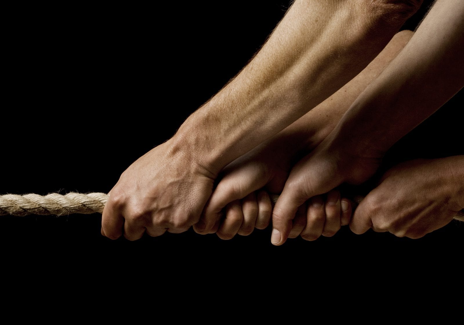 Hands Pullling Together On Rope